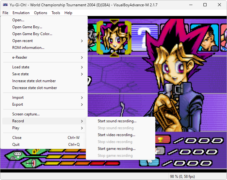 Captura de tela demonstrativa do Visual Boy Advance mostrando seu menu "File" aberto com o destaque para sua opção "Record" que permite gravar a jogabilidade dos jogos. Há um jogo sendo rodado no fundo, o Yu-Gi-Oh! World Championship Tournament 2004.